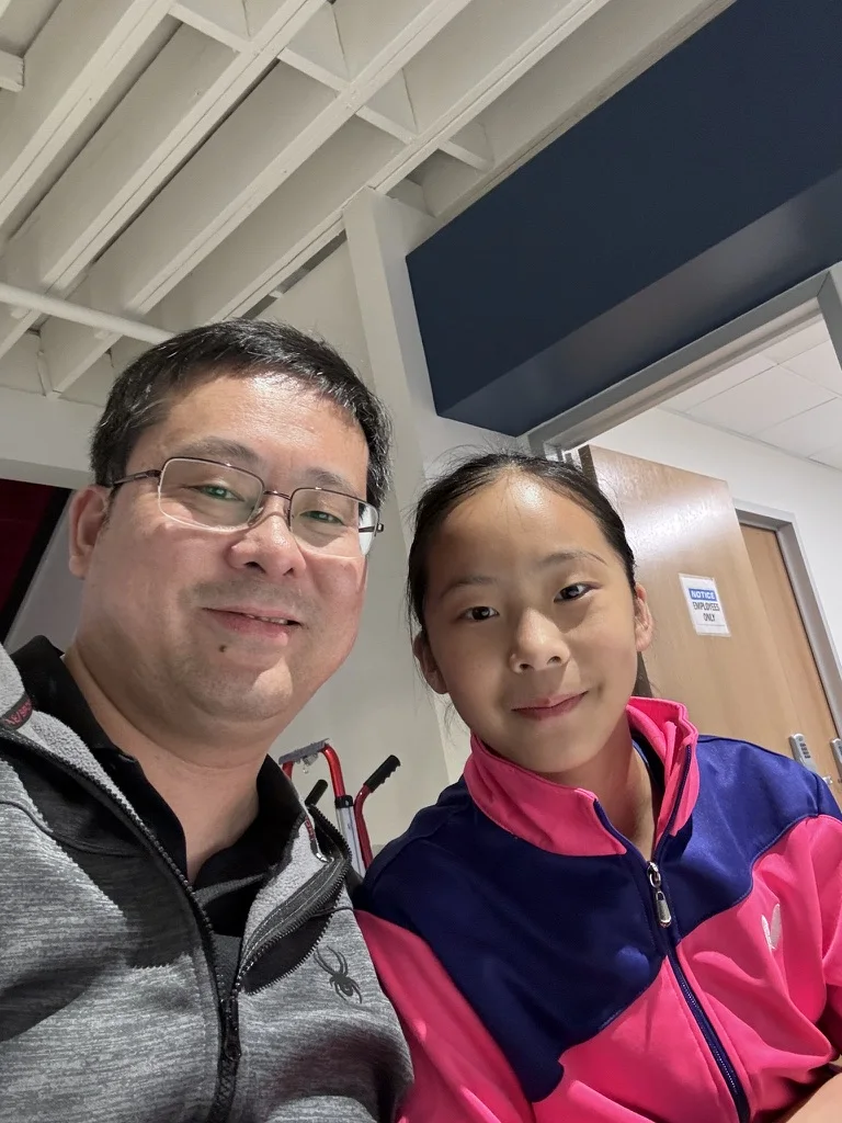 Jon Zhu and his daughter Cindy smiling for a selfie